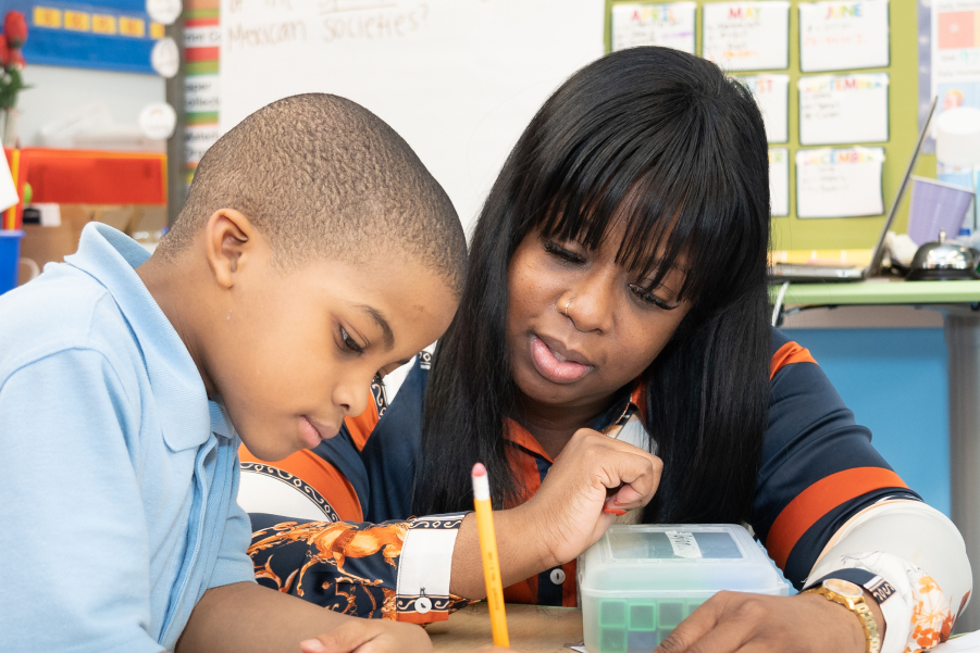 Teacher helping student